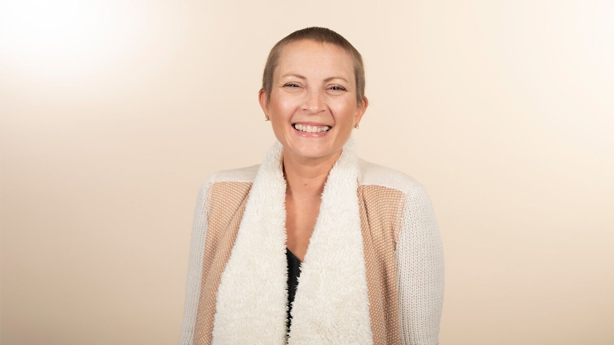 A white woman smiling.