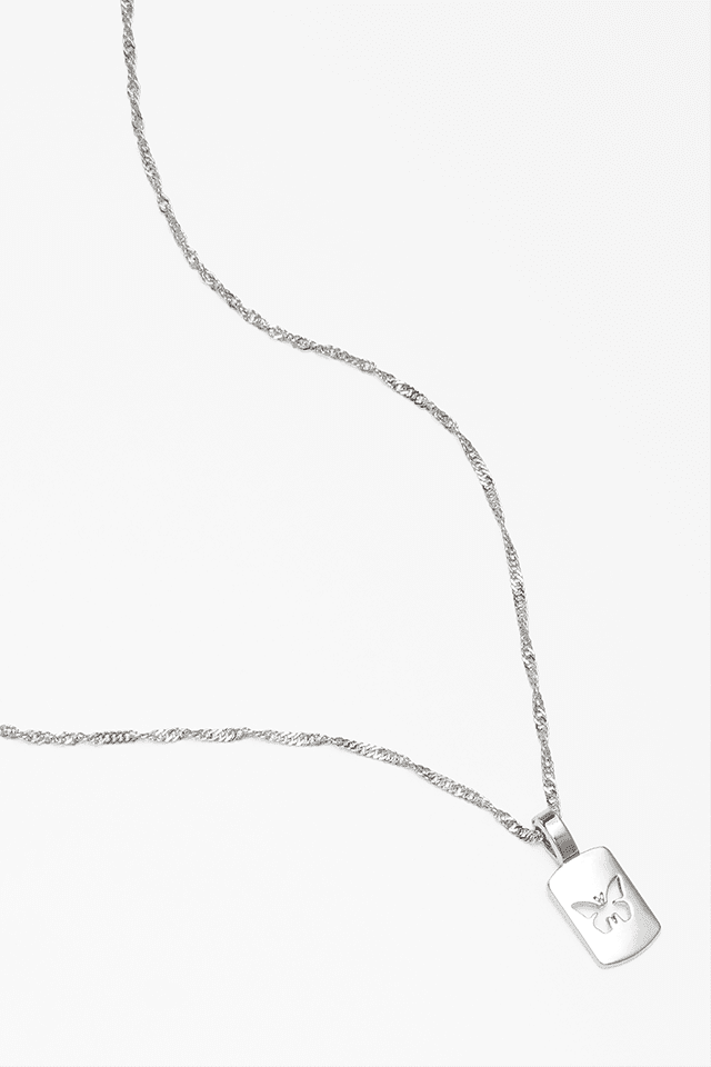 A silver necklace with the imprint of a butterfly.